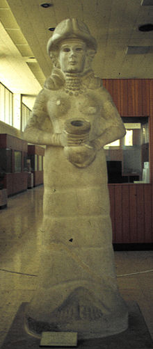 4 - giant alien goddess Inanna statue with her in her flight suit, oxygen hose running down her back